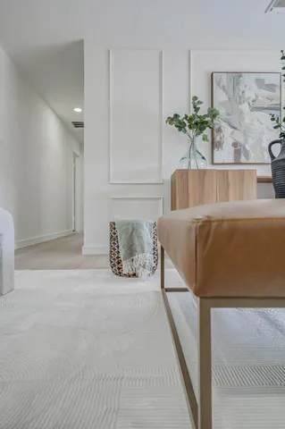 a living room with furniture and a potted plant