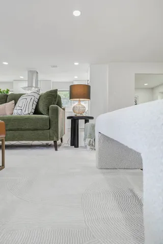 a spacious bedroom with a bed and a couch