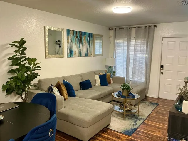 a living room with furniture potted plant and a window