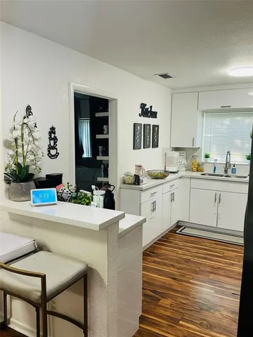 a kitchen with granite countertop a stove and a microwave