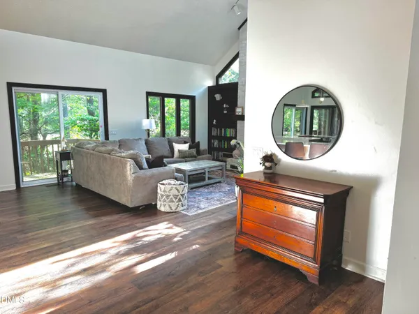 a living room with furniture a fireplace and a large window