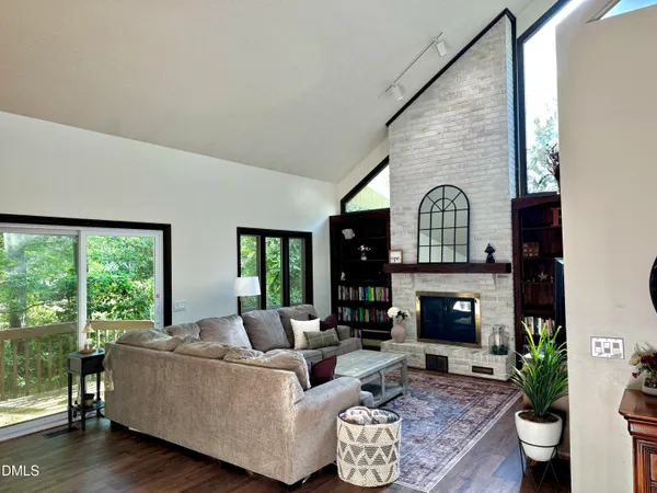 a living room with fireplace furniture and a wooden floor