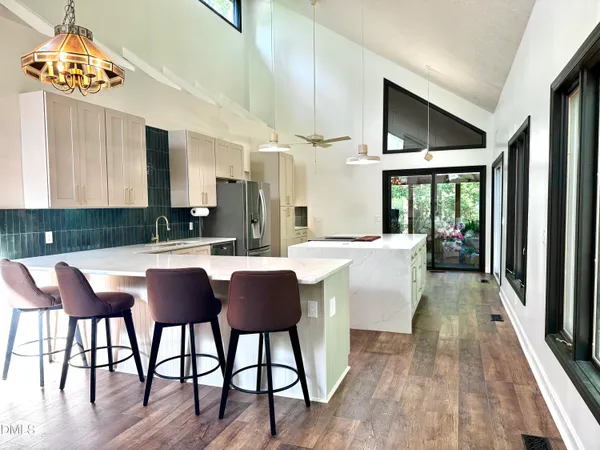 a kitchen with stainless steel appliances granite countertop a stove a sink and a refrigerator