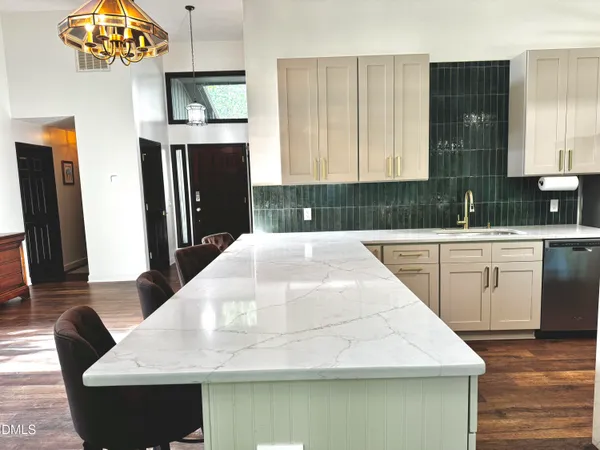 a kitchen with stainless steel appliances a refrigerator and a stove