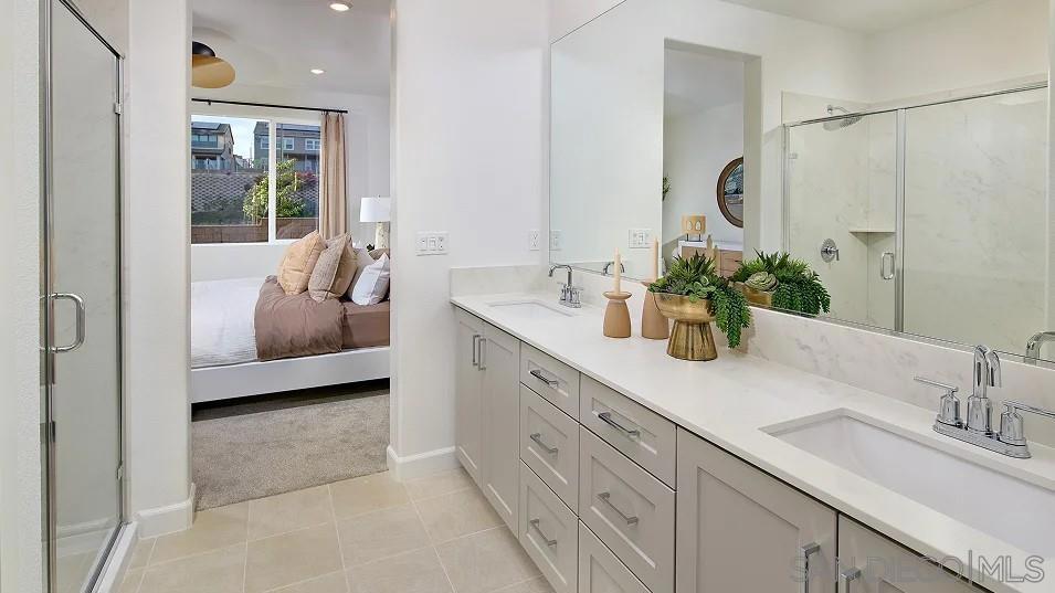 1057 Spike Street, Unit 2 Chula Vista, CA 91911 - Photo 14 of 18 a bathroom with double vanity sink a two mirror a window and shower