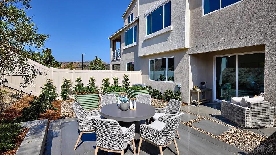 1057 Spike Street, Unit 2 Chula Vista, CA 91911 - Photo 16 of 18 a view of a patio with table and chairs and potted plants
