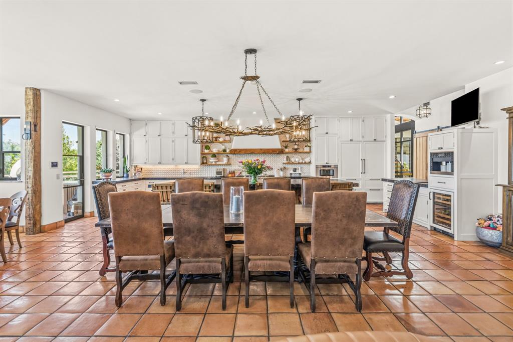 321 Verna Trail North Fort Worth, TX 76108 - Photo 11 of 40 a dining room with furniture a chandelier and wooden floor