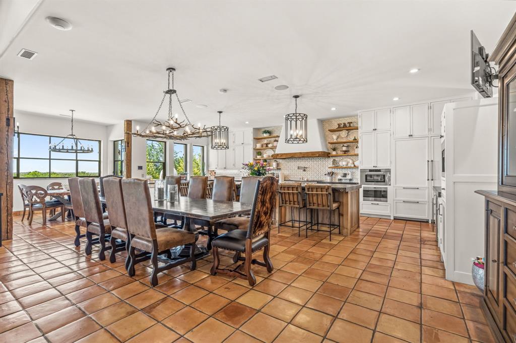 321 Verna Trail North Fort Worth, TX 76108 - Photo 12 of 40 a dining hall with stainless steel appliances a dining table and chairs with the view of kitchen
