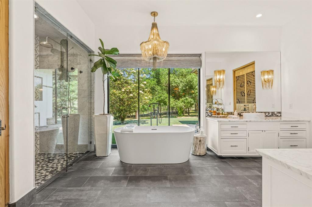 321 Verna Trail North Fort Worth, TX 76108 - Photo 20 of 40 a bathroom with a bathtub sink and mirror
