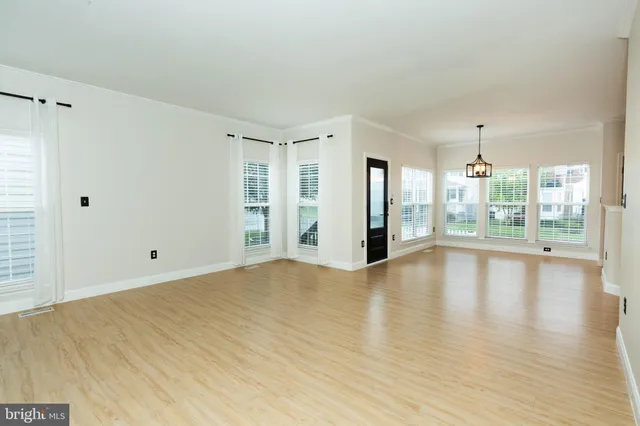 a view of an empty room with glass door