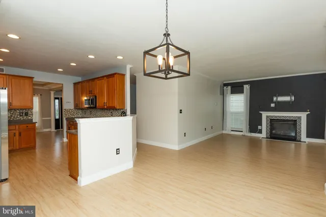 a view of a kitchen with a sink and a fireplace