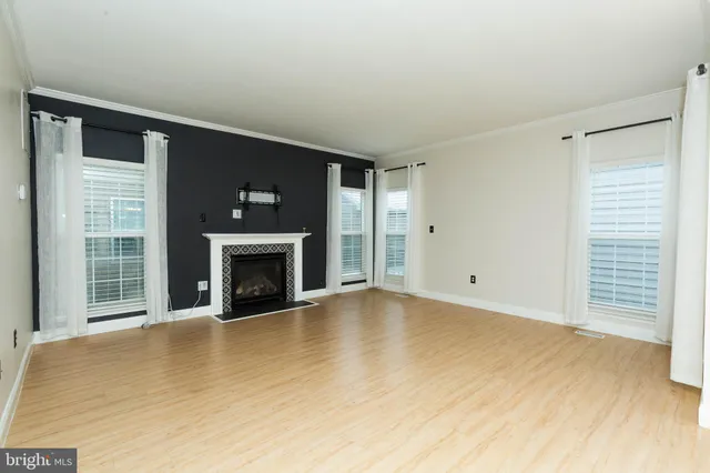 a view of empty room with a fireplace
