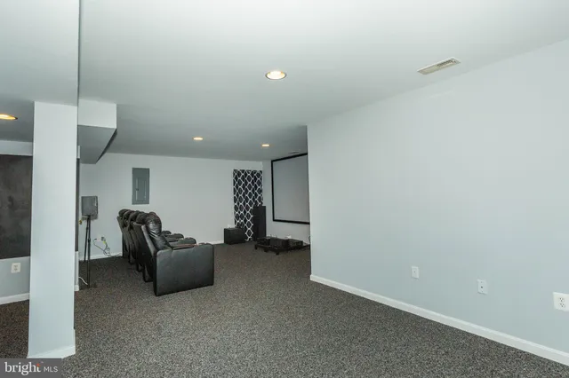 a living room with furniture gym equipment and a large window