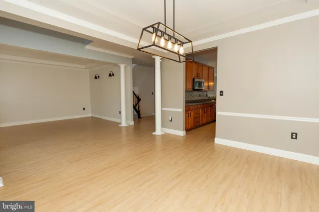 a view of a room with wooden floor and window