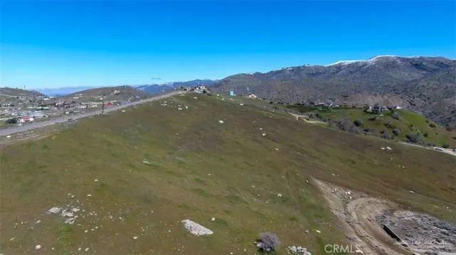 a view of a mountain with a mountain in the background