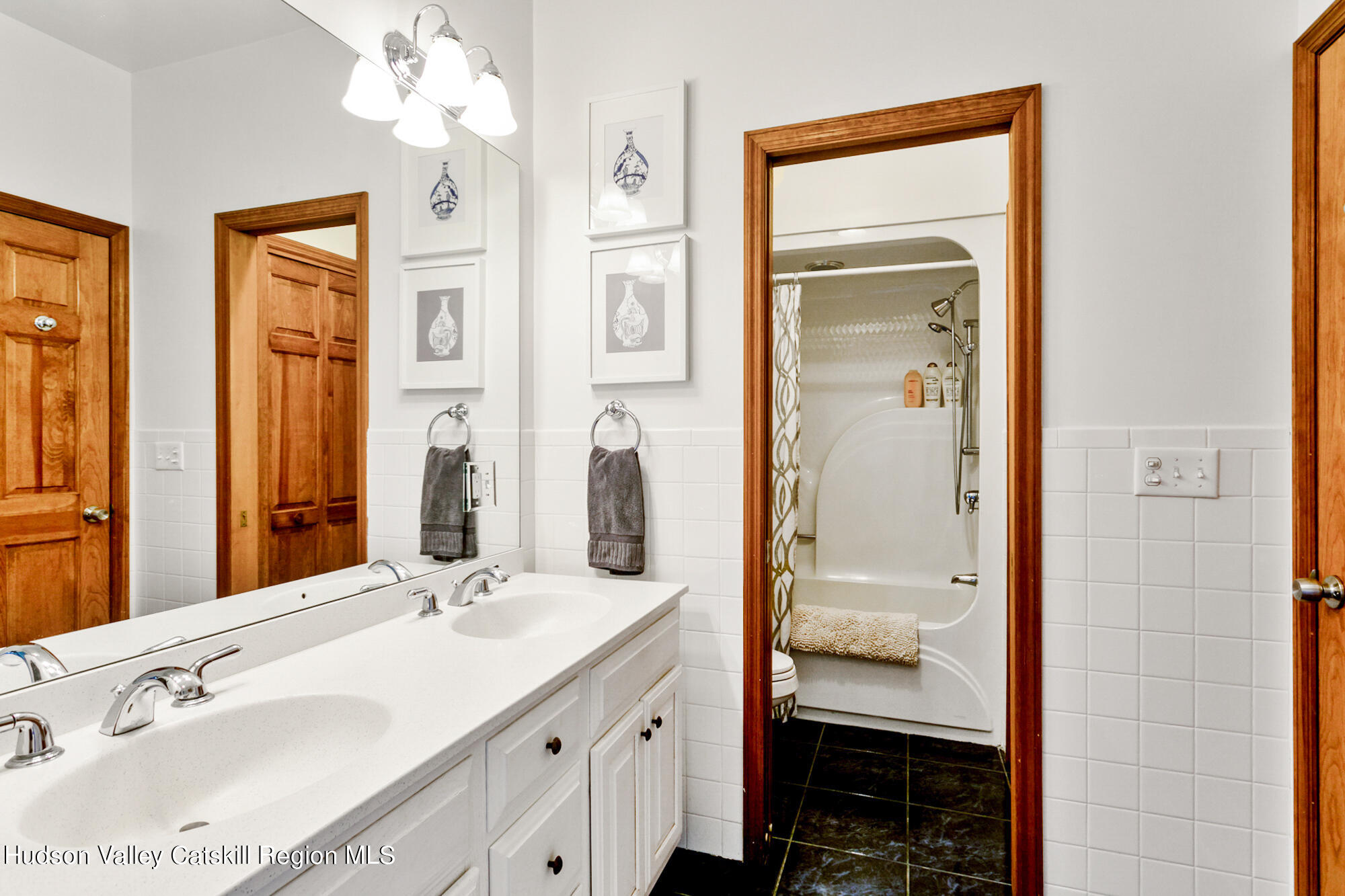 742 Embought Road Catskill, NY 12414 - Photo 17 of 30 a bathroom with double vanity sink a two mirror a window and a glass door
