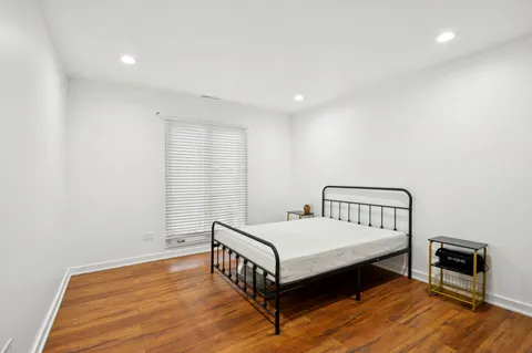 a spacious bedroom with a bed and a window