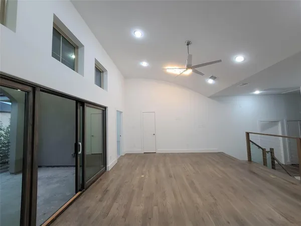 a view of empty room with wooden floor