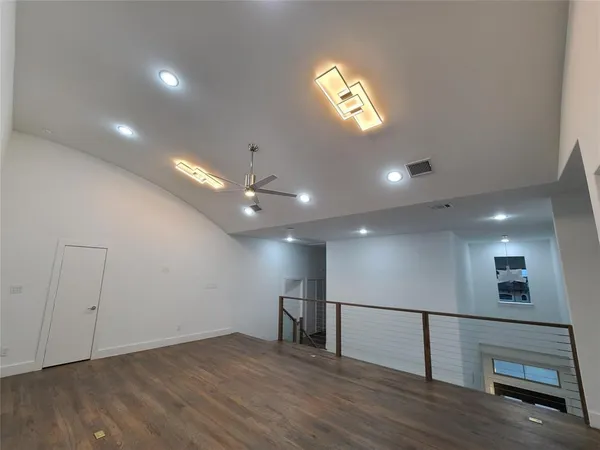 a view of an empty room with glass door and a window
