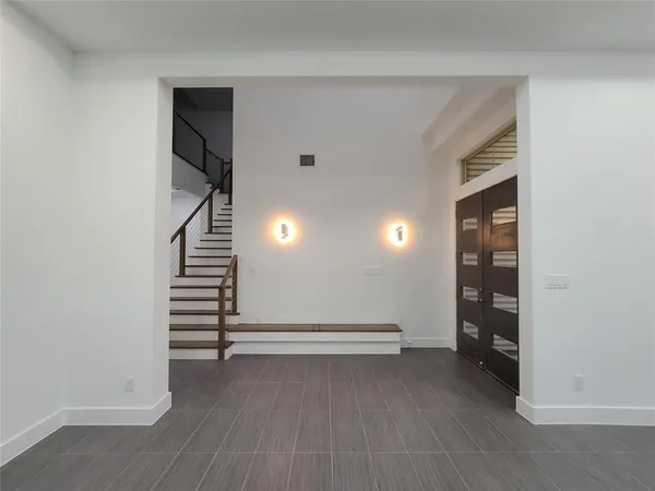 a view of room with stairs and a hallway