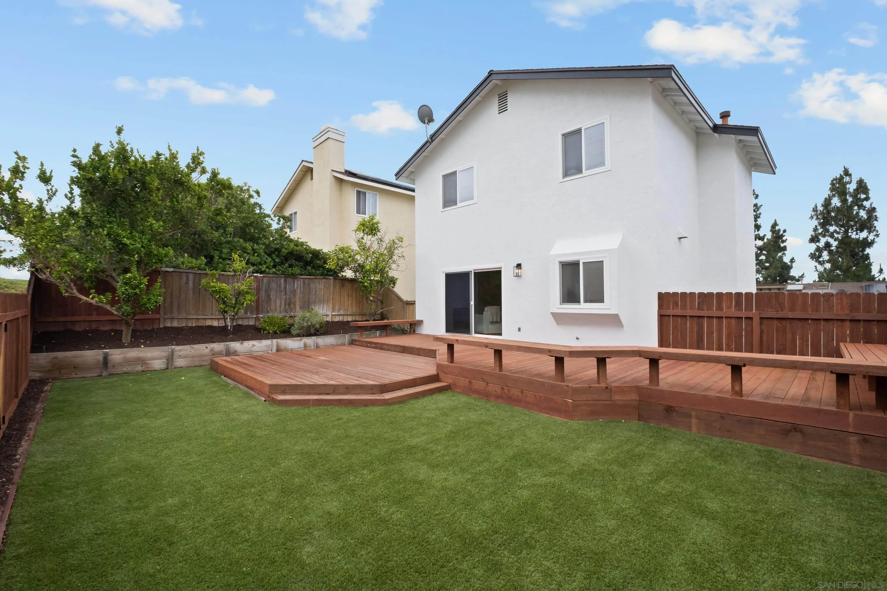 11478 Madera Rosa Way San Diego, CA 92124 - Photo 17 of 54 a view of a house with a backyard and a patio