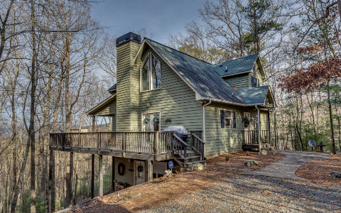 a view of a house with a small yard and furniture