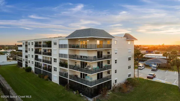 a view of a balcony with a floor to ceiling window and yard