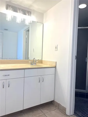 a bathroom with a shower toilet and sink