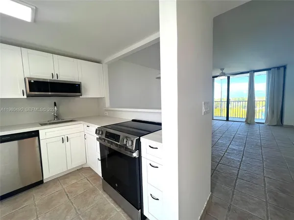 a kitchen with a refrigerator and a sink