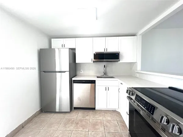 a view of an empty room with glass door