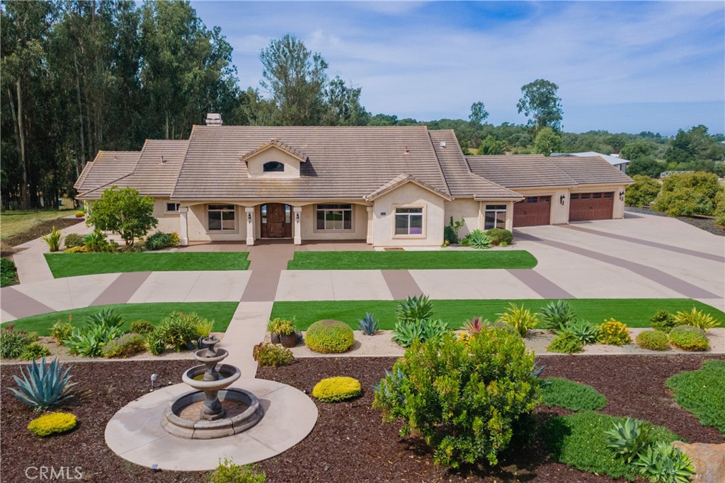 520 Stanton Street Arroyo Grande, CA 93420 - Photo 1 of 45 a view of a white house with a big yard and potted plants