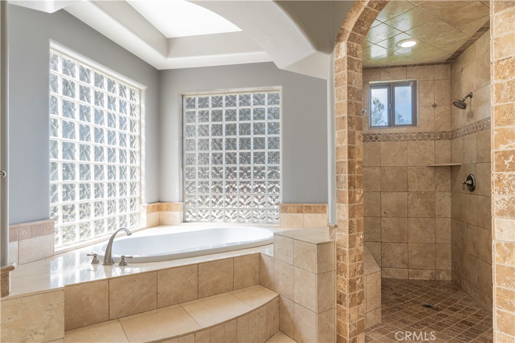 520 Stanton Street Arroyo Grande, CA 93420 - Photo 21 of 45 a bathroom with a bathtub and a shower