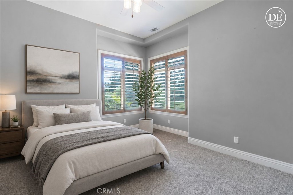 520 Stanton Street Arroyo Grande, CA 93420 - Photo 24 of 45 a bedroom with a bed and a painting on the wall
