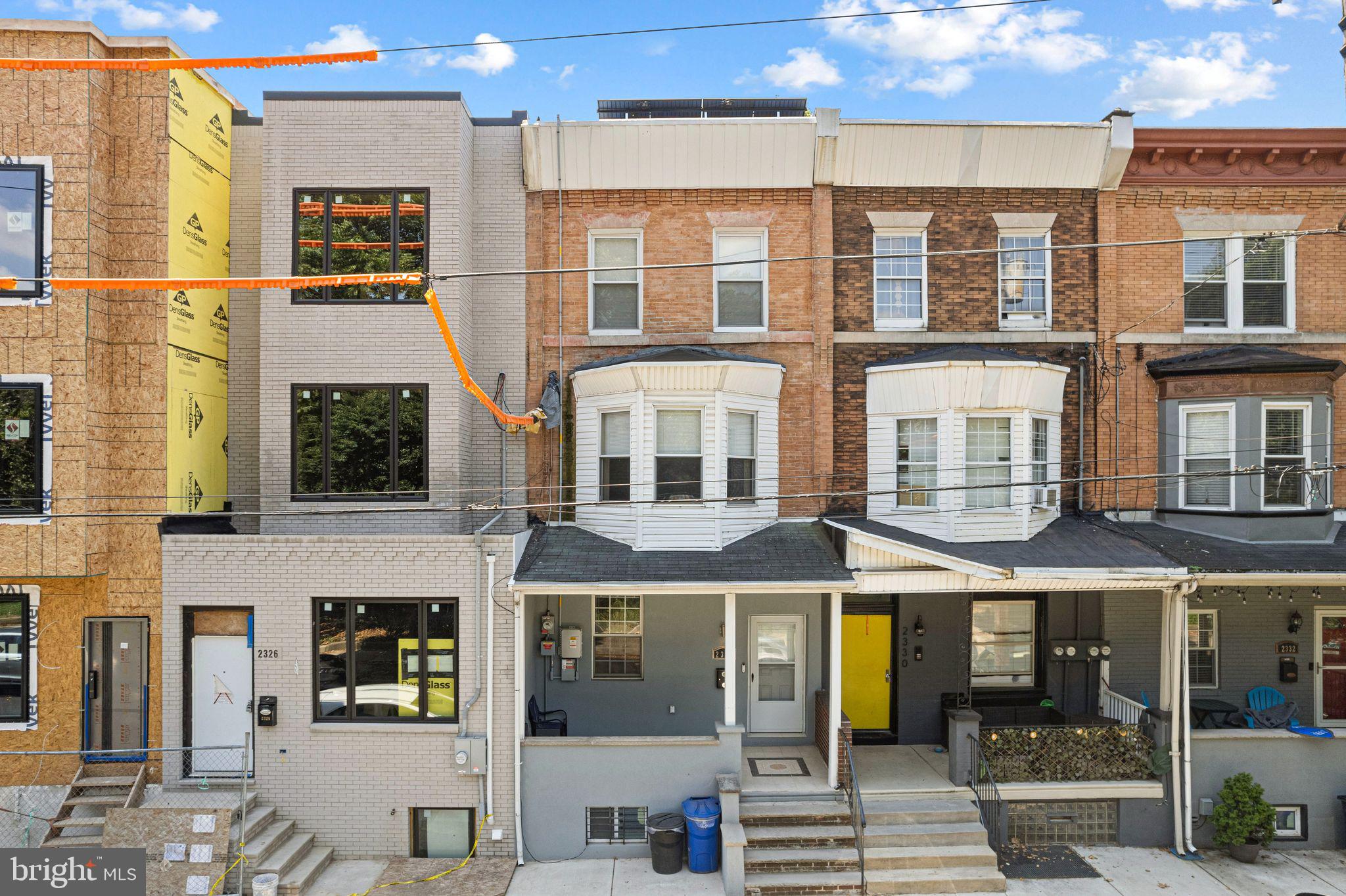 a front view of a brick building with large windows