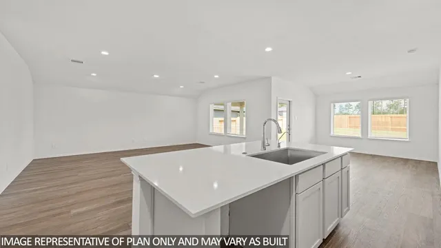 a kitchen with sink and mirror