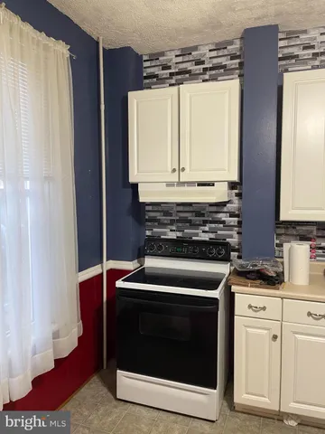 a kitchen with a stove and a microwave