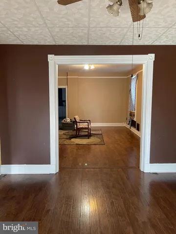 a view of a livingroom with wooden floor and furniture
