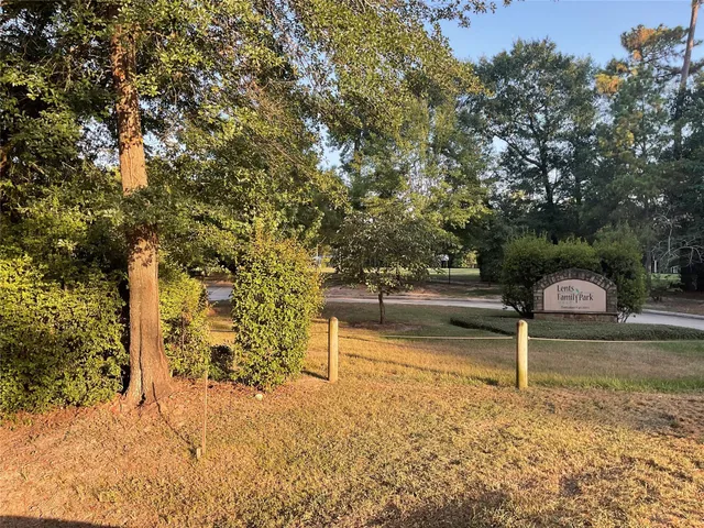 a view of a yard with wooden fence