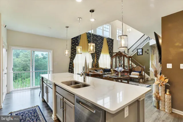 a kitchen with a sink a large window and a refrigerator