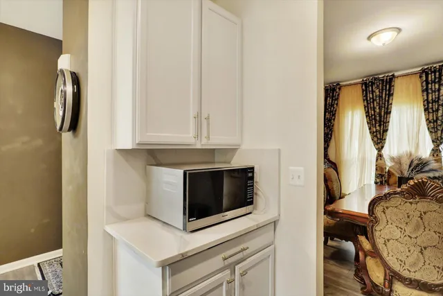 a kitchen with stainless steel appliances white cabinets and a refrigerator