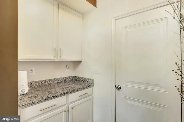 a kitchen with granite countertop cabinets and refrigerator