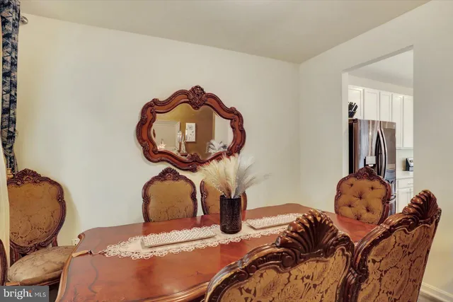 a living room with stainless steel appliances furniture and a flat screen tv