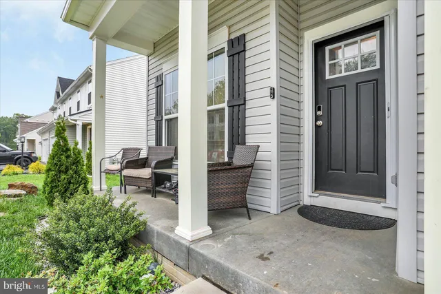 a backyard of a house with barbeque oven table and chairs