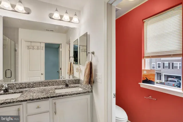 a bedroom with a bed and a night stand