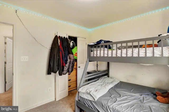 a bed sitting in a bedroom next to a window