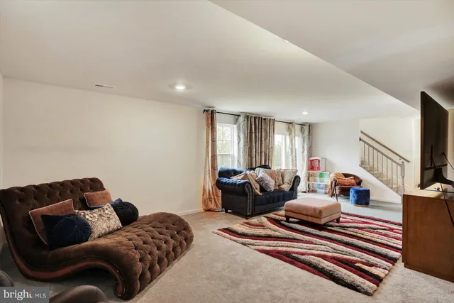 a bedroom with furniture and a flat screen tv