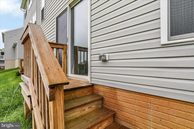 a front view of a house with a yard and potted plants