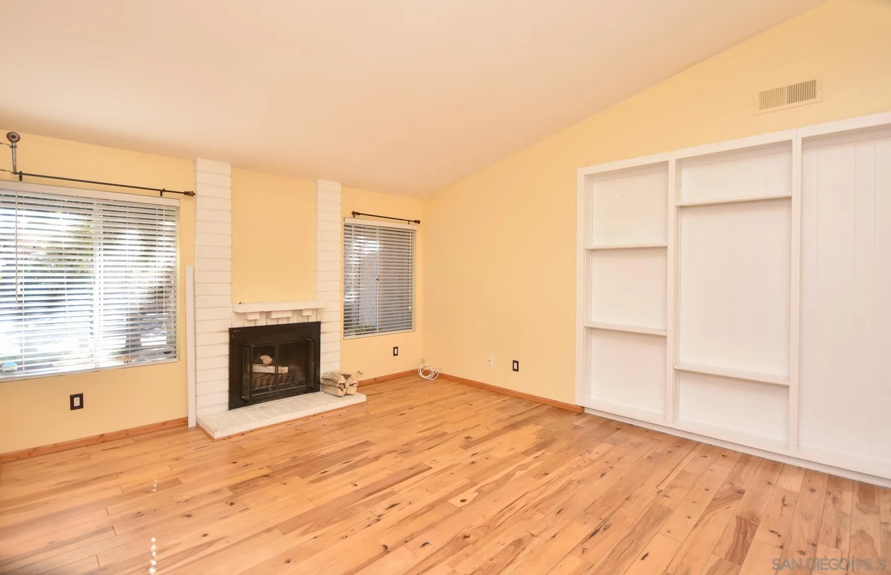 455 Mainsail Road Oceanside, CA 92054 - Photo 2 of 17 a view of empty room with wooden floor and fireplace