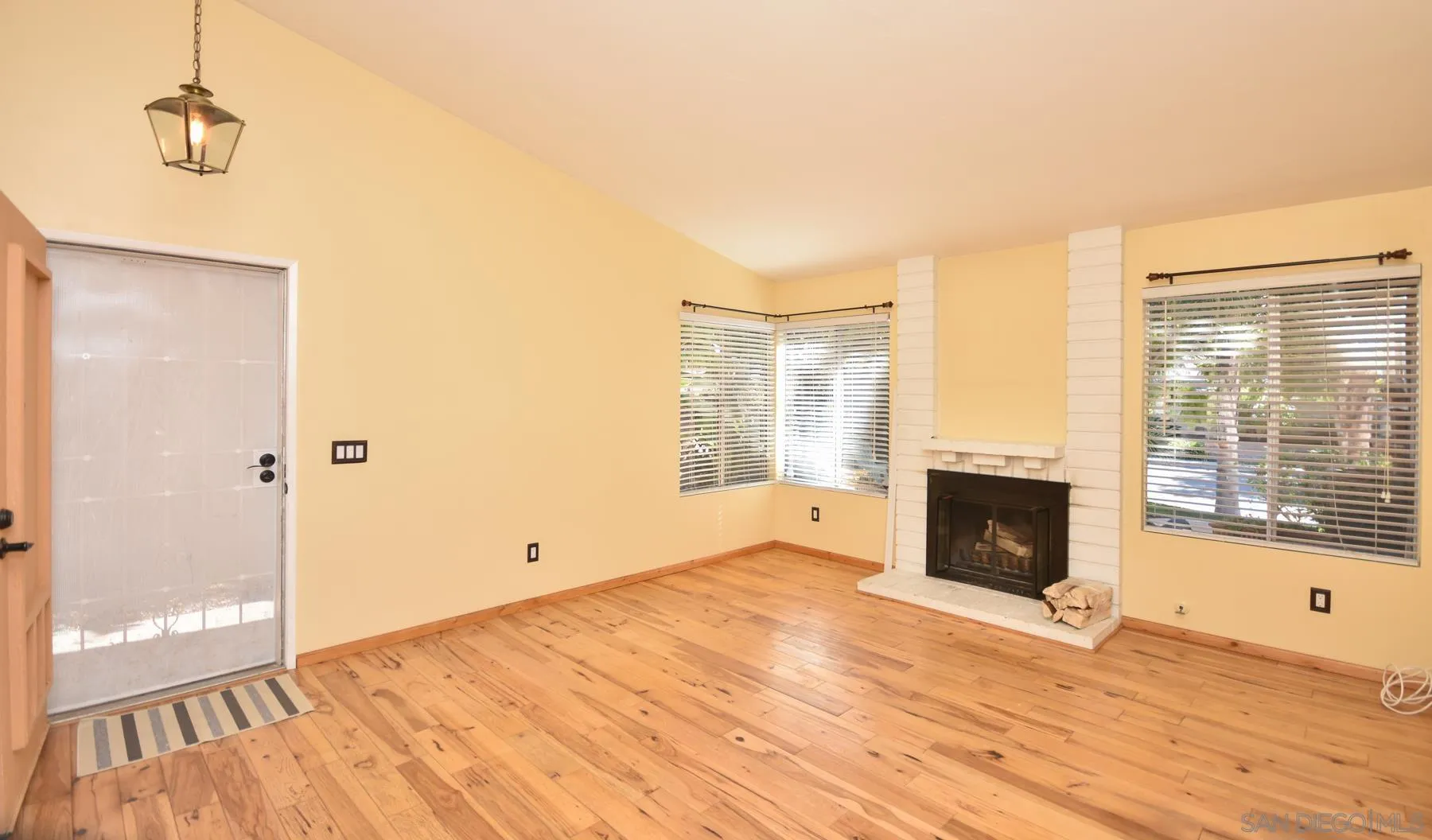 455 Mainsail Road Oceanside, CA 92054 - Photo 3 of 17 a view of empty room with wooden floor and fireplace
