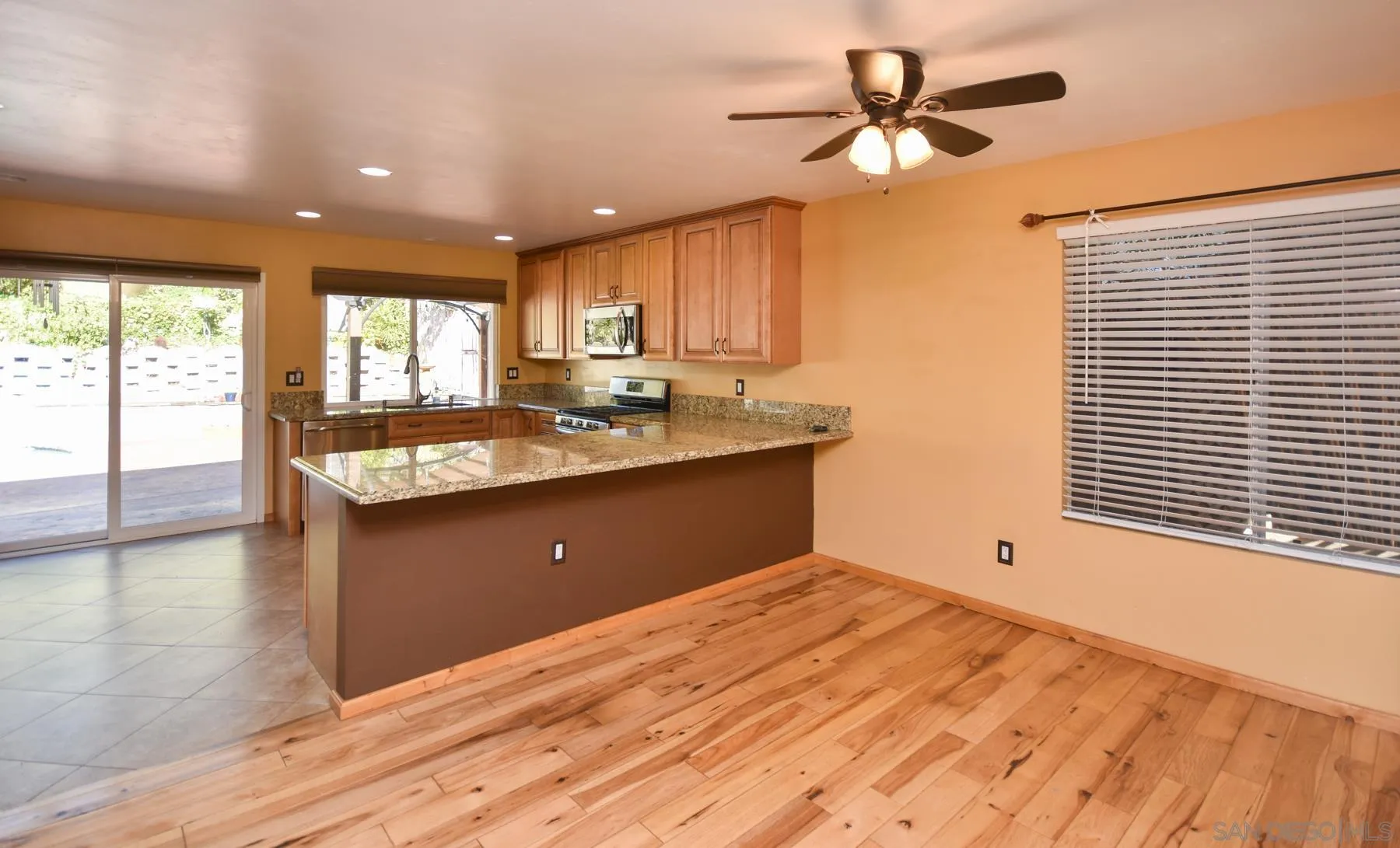 455 Mainsail Road Oceanside, CA 92054 - Photo 4 of 17 a spacious bathroom with a granite countertop sink a window and a mirror